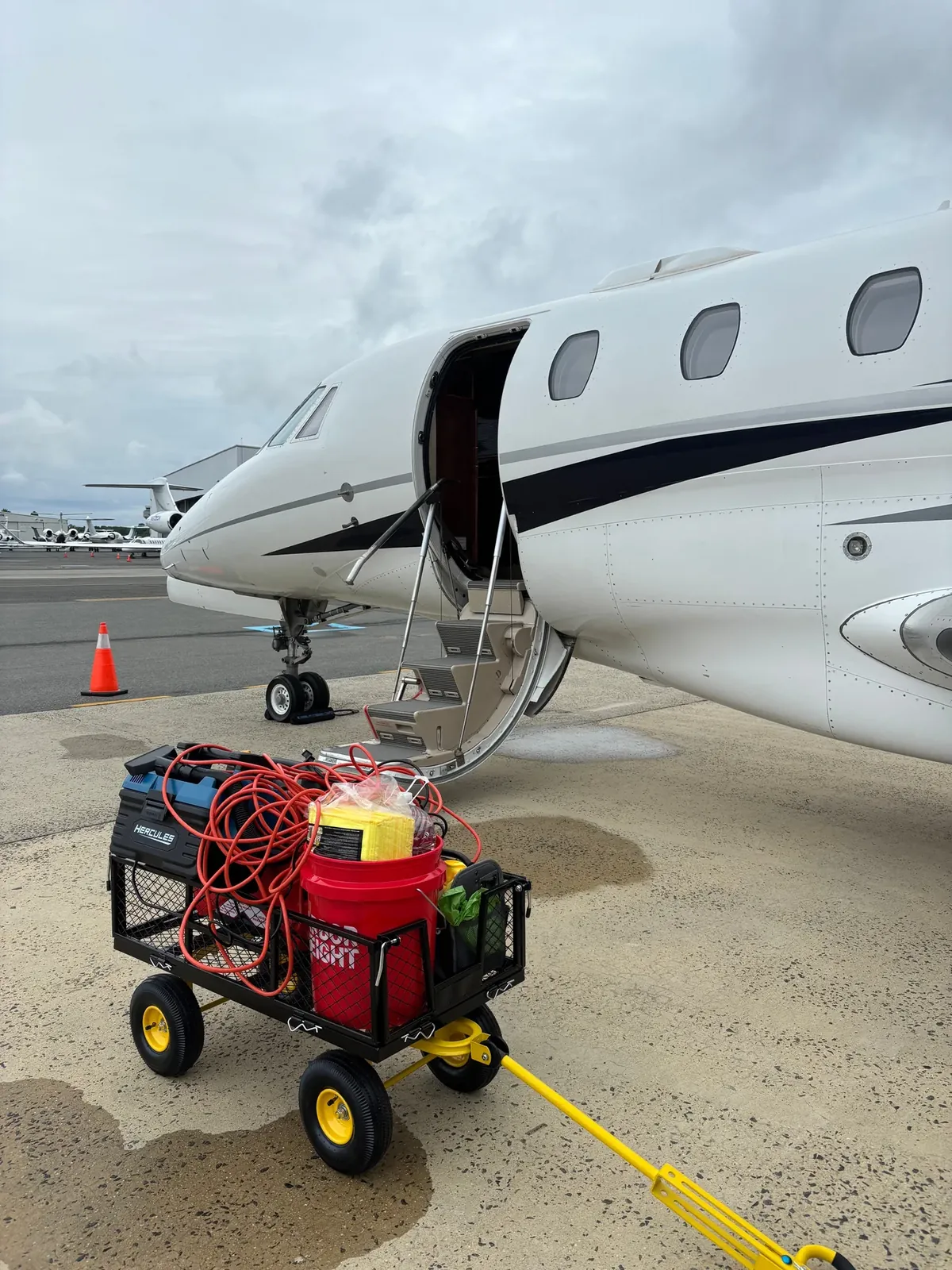 Aircraft detailing equipment staged beside a business aircraft